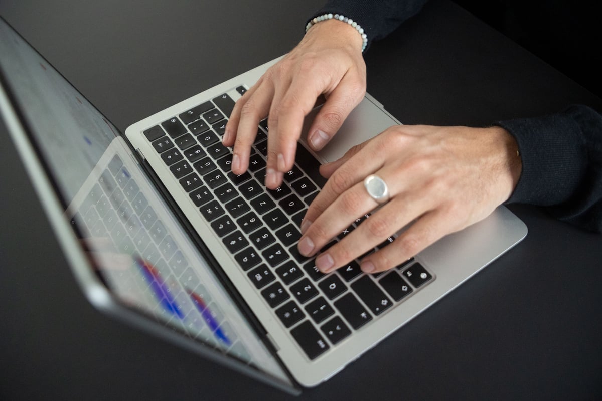 Hands on the laptop